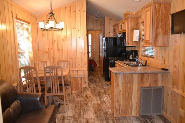 Sip coffee at the dining table in a sunny, rustic interior.