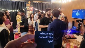 A group of people in a room with a sign reading 'when do you feel most like you?'