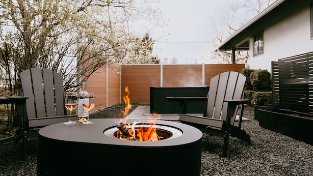 An outdoor seating area with a fire pit, two Adirondack chairs, and a table. - Swanky Speakeasy Stay-Hot Tub + Firepit-Minutes to Downtown (Moscow)