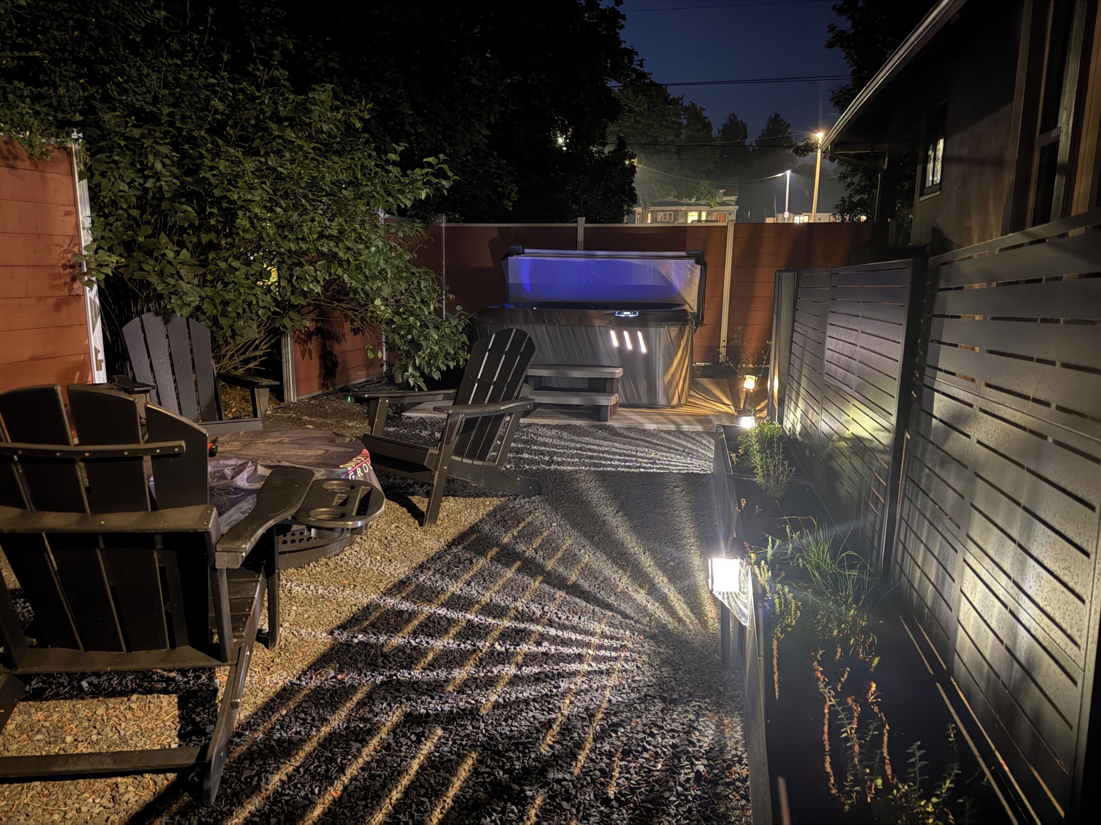 An outdoor patio with a barbecue grill, seating area, and a small pool.
