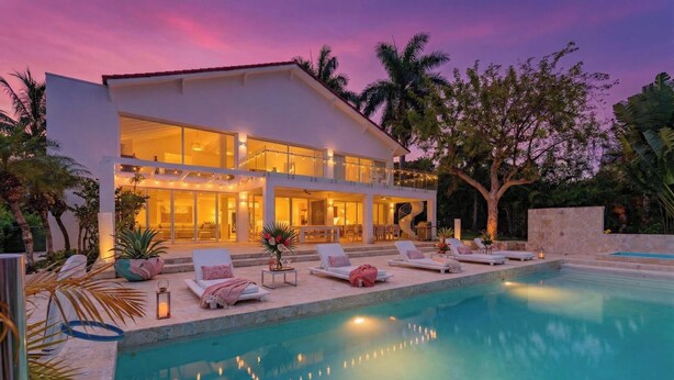 A modern two-story house with a swimming pool, outdoor seating, and a staircase leading to the upper level. - 5BR Hispaniola Villa in Sosua (Sosúa)