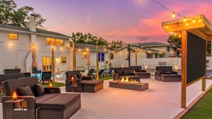 A patio area with outdoor furniture, a fire pit, and string lights. - GAME ON! Heated Pool, Pickleball, Outdoor Theater! (Seminole)