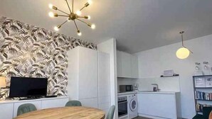 A compact kitchen with a microwave, oven, and sink. - Holiday apartment with pool and balcony with lake view (Pieve di Ledro)