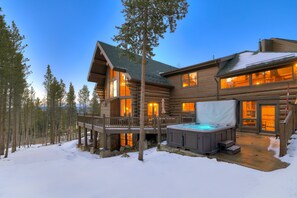 A log cabin with a hot tub, deck, and snowy surroundings. - The Ski Classic Lodge - Hike in / out at Peak 8 in the best location in Breck (Breckenridge)