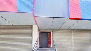 A staircase leading to a closed entrance with metal railings and a red door.