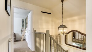 A staircase with a handrail, a light fixture, and a mirror. - Roundhill Farm Cottage - Naunton, Bourton-on-the-Water, sleeps 4 guests  in 2 bedrooms (Cheltenham)