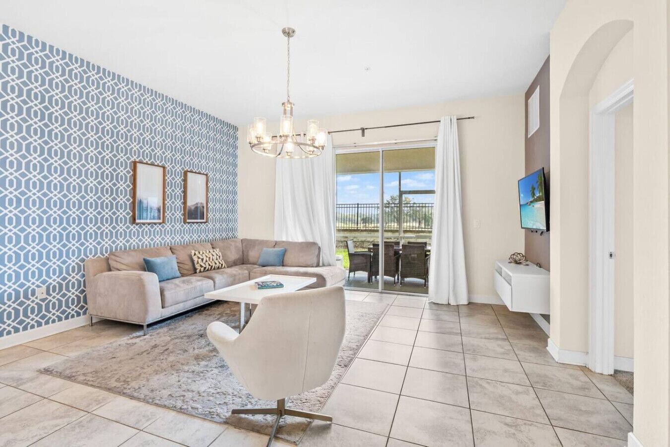 A living room with a sofa, coffee table, and TV.