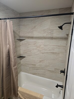 Shower, hair dryer, towels, toilet paper