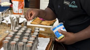 A chef preparing food in a kitchen with a tray of food and condiments. - Casa Delmar: Private Beachfront Estate with Chef, 2 Butlers ,Staff & Ocean Views (La Romana)