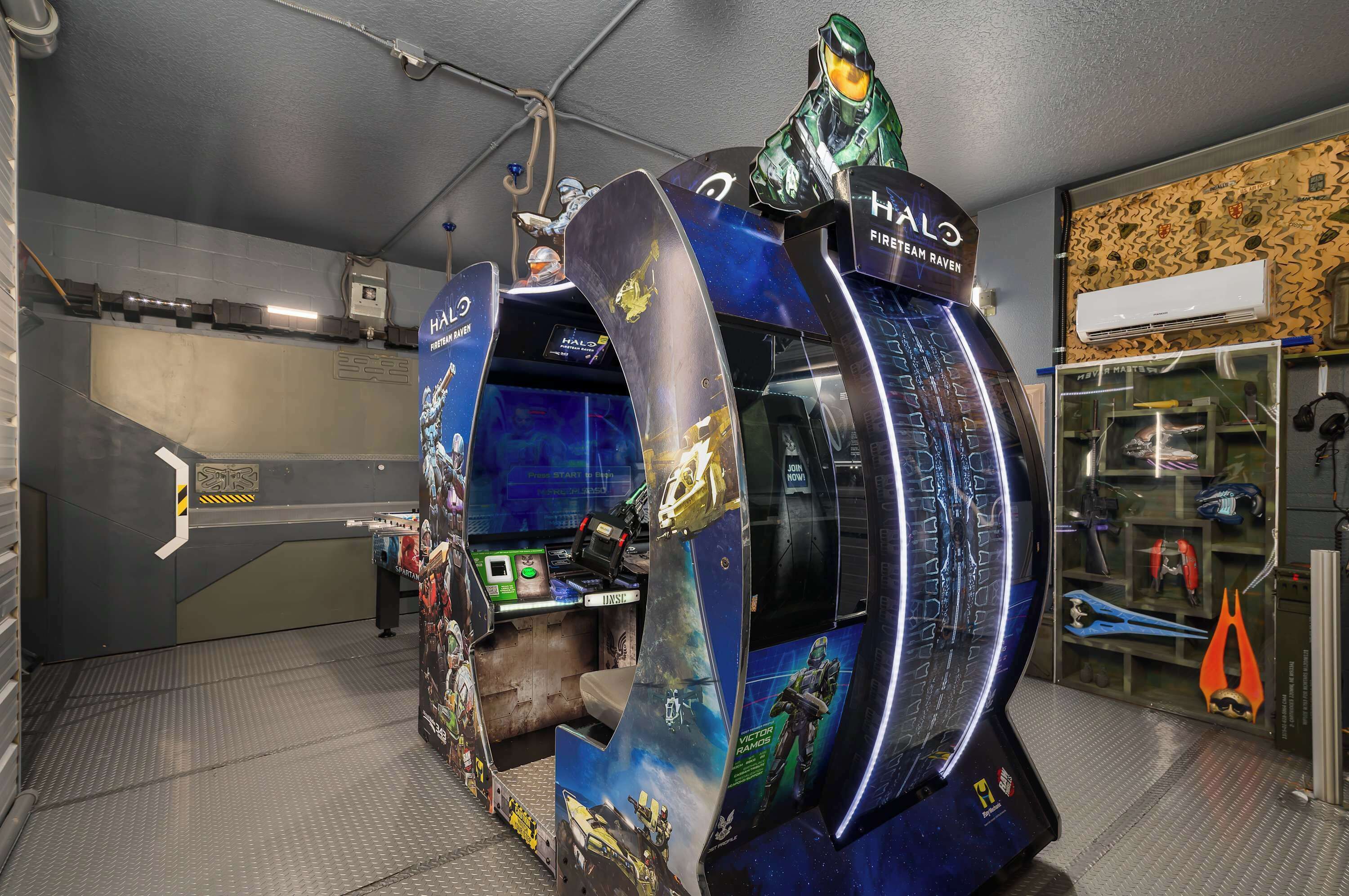 A gaming arcade with a Halo-themed design, including a large circular structure and a control panel.