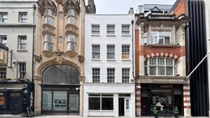 A row of buildings with distinct architectural styles, including a white facade, a red brick building, and a building with ornate detailing. - Opulenti Mayfair 1BR Residence (London)