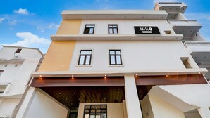 A hotel with a modern design, featuring a signboard with the name 'HOTEL' and a company name. - Super Hotel O Indira Nagar (Lucknow)