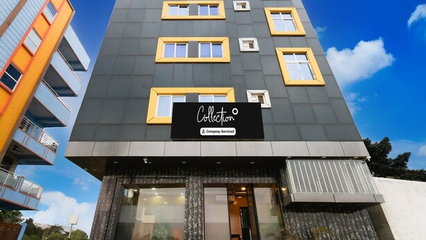 A multi-story building with a sign reading 'Collection Company serviced.'