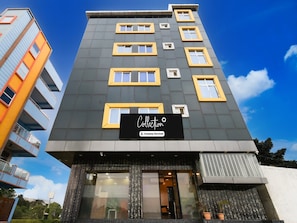 A multi-story building with a sign reading 'Collection Company serviced.'