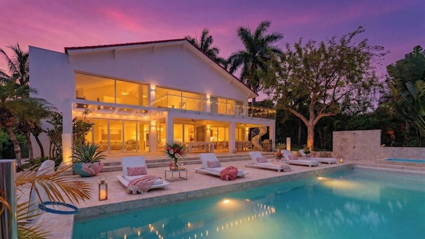 A modern two-story house with a swimming pool, outdoor seating, and a staircase leading to the upper level. - 5BR Hispaniola Villa in Sosua (Sosúa)