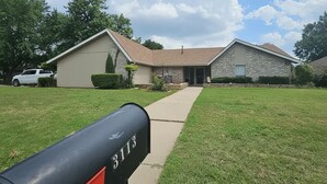 A residential house with a mailbox in the foreground. - Spacious 4-bedroom 2 bath house equipped with AC. Sleeps up to 12 people. (Lawton)