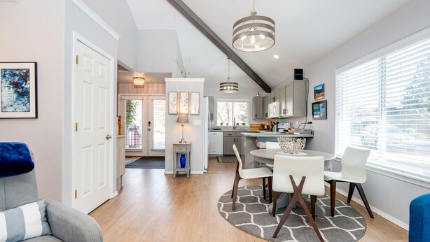 A modern kitchen with a central island, white cabinetry, and pendant lighting. - Elegant Fairway Frontage Retreat-Eagle Crest Resort 3BD 2.5BA Centrally Located (Redmond)