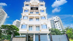 A multi-story building with a sign reading 'Townhouse & Company Services.' - Deluxe Rosedale Reliance Guest House (Barasat)