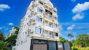 A multi-story building with a sign reading 'TOWNHOUSE' and a gated entrance. - Deluxe Rosedale Reliance Guest House (Barasat)