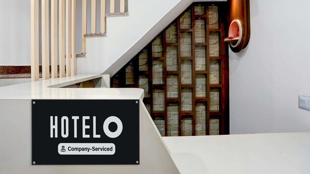 A hotel reception area with a staircase, a reception desk, and a sign indicating the hotel is company-serviced. - Classic With Balcony Dashashwamedh Ghat Varanasi (Varanasi)
