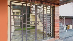 A metal gate with a staircase leading to a building entrance. - Premium Hotel O IIM Road Lucknow (Bakshi Ka Talab)