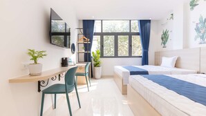 A modern hotel room with a bed, a desk with a chair, a TV mounted on the wall, and a window with curtains. - Bin Bin Hotel 18 - Near Thu Thiem Villa Park (Ho Chi Minh City)