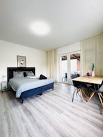 Basic Apartment | Laptop workspace, iron/ironing board