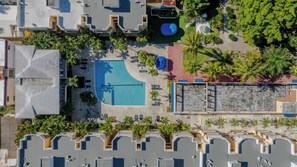 An aerial view of a hotel with a swimming pool, palm trees, and a rooftop terrace. - Garden Condos 35 Best Stylish apartment in Sosua (Sosúa)