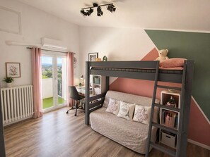 A room with a bunk bed, a desk, a chair, a radiator, and a view through a glass door. - Villa Ventoux - 100% Private - 2 steps from Avignon (Villeneuve-lès-Avignon)