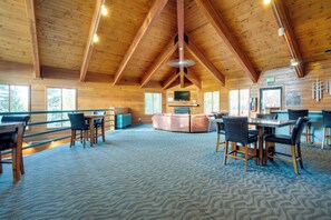 A spacious lodge with a high ceiling, wooden beams, a central seating area, and a television. - All-Season Base w/ Epic Views in Silverthorne! (Silverthorne)