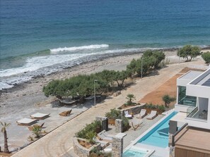 A resort with a swimming pool, beach area, and ocean view. - Moonlight Villas Calypso Sleek Coastal Living by etouri (Ierapetra)