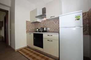 A compact kitchen with a built-in dishwasher, a stove, and a refrigerator. - Villa in Marina Di Ragusa with 5 bedrooms sleeps 13 (Marina Di Ragusa)