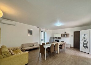 A compact living space with a dining area, kitchenette, and a sofa. - Villa in Marina Di Ragusa with 5 bedrooms sleeps 13 (Marina Di Ragusa)