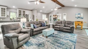 A spacious living room with a large sectional sofa, a coffee table, and a ceiling fan. - 2 Mi to Dale Hollow Lake! 'Shadowood' Group Escape (Byrdstown)