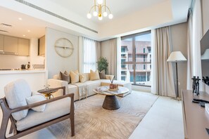 Ein modernes Wohnzimmer mit Sofa, Couchtisch und Essbereich.