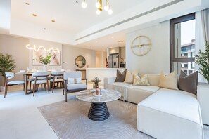 Ein modernes Wohnzimmer mit einer Couch, einem Esstisch, Stühlen und einem Couchtisch.