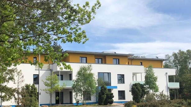 A modern multi-story building with a flat roof, large windows, and a central entrance. - 3 Person Holiday Park Home in Sassenburg (Sassenburg)