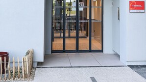 A hotel entrance with a modern design, featuring a glass door and a sign above that reads 'OSMO HOTEL'. - The Originals Boutique Osmo Hôtel (Chantepie)