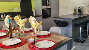 A modern kitchen with a dining area set for a meal.