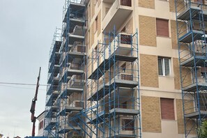A multi-story building with external scaffolding, indicating construction or renovation. - SE234 – Senigallia, three-room apartment in the center with terrace and air conditioning (Senigallia)