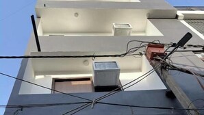 A modern building with a flat roof, a visible air conditioning unit, and a window. - Hotel Prime Stay (New Delhi)