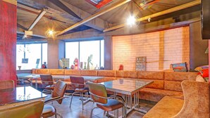 A restaurant interior with booths, tables, and chairs.
