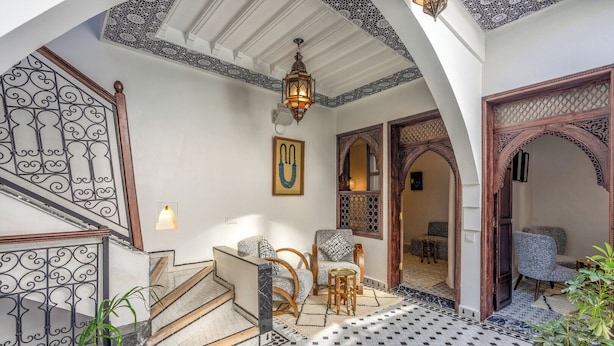 A traditional interior with a staircase, seating area, and decorative elements. - Riad Nostalgia & Spa (Marrakech)