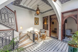 A traditional interior with a staircase, seating area, and decorative elements. - Riad Nostalgia & Spa (Marrakech)