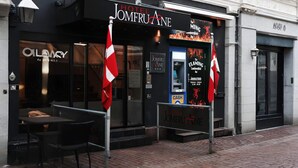 A hotel entrance with a black facade, a reception desk, and a cash machine. - 1 Person Holiday Park Home in Aalborg (Aalborg)