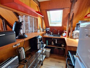 A compact kitchen with a sink, stove, and various appliances. - Charming chalet, panoramic view - 5 guests (Saint-Michel-de-Chaillol)