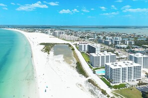 A coastal cityscape with a beach, high-rise buildings, and a clear sky. - Creciente 506S Beachfront 2B/2B Island Vacation Condo, Gulf View, Resort Pool (Fort Myers Beach)