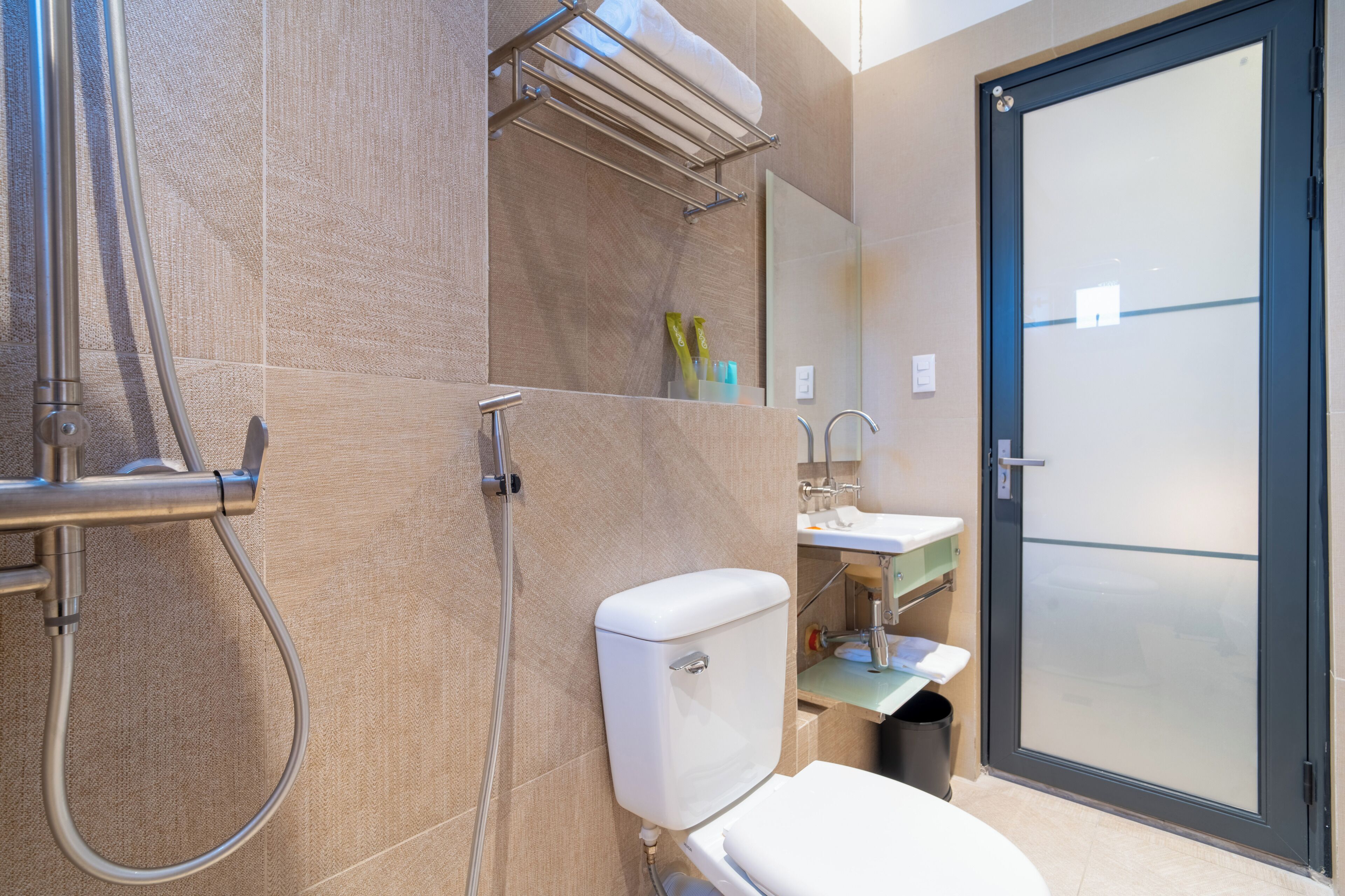 A modern bathroom with a toilet, sink, and shower.