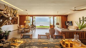 A spacious living area with a view of the sea, wooden furniture, and a modern design. - Beachfront retreat in Preá, with pool, rooftop, massage room and gym. (Caiçara)