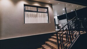 A staircase with a metal railing leading to a landing. - Misteph Luxury Living (Kigali)